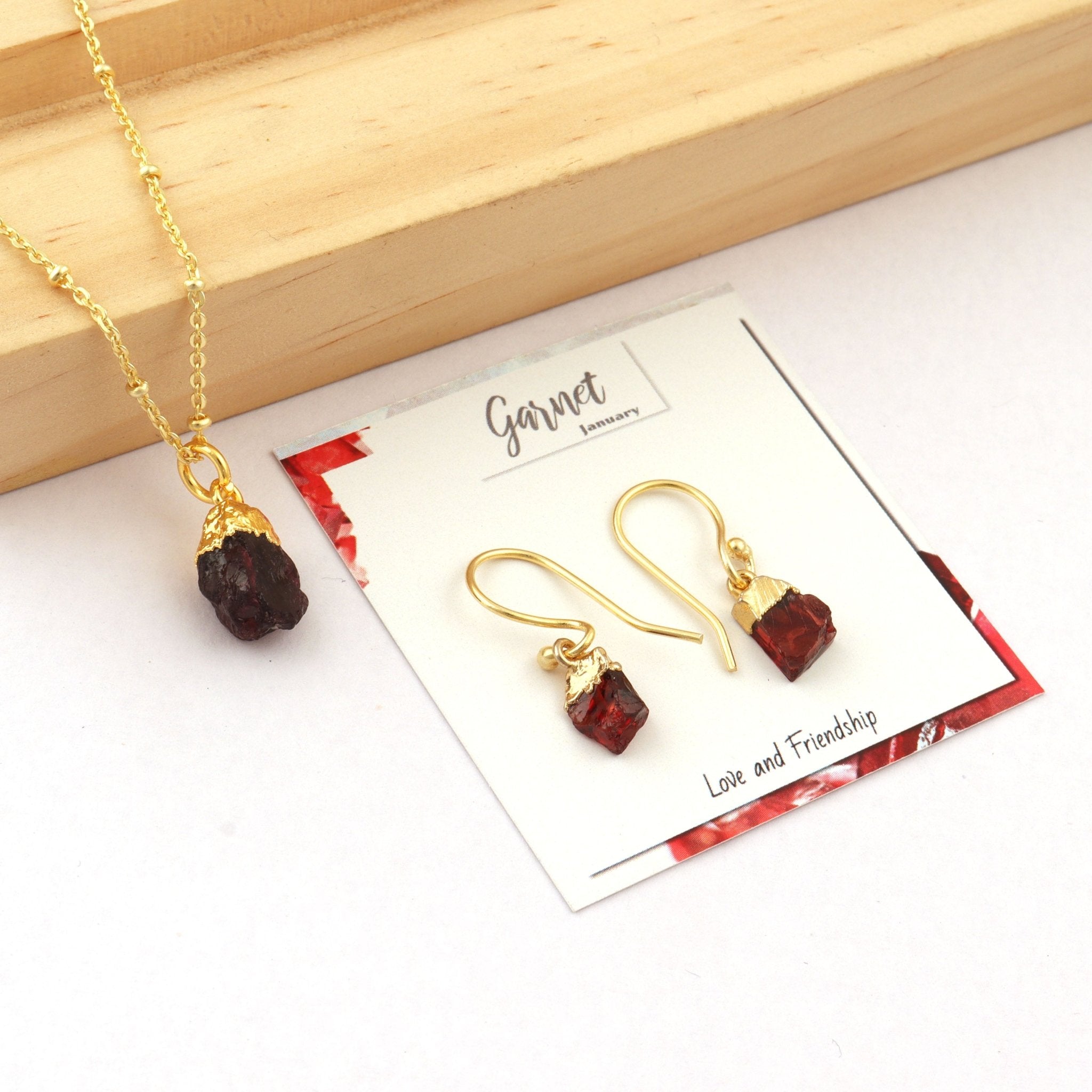 a collection of gold plated garnet earring and necklace