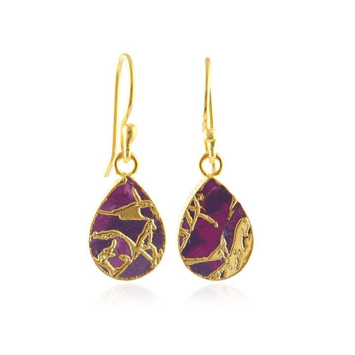 Gold earrings with purple amethyst stone on a white background
