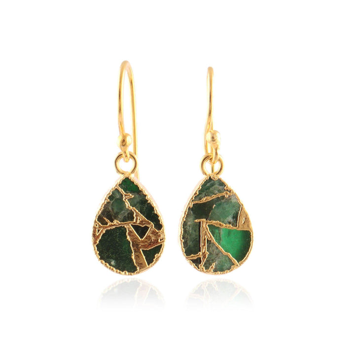 Gold earrings with green stone accents on a white background