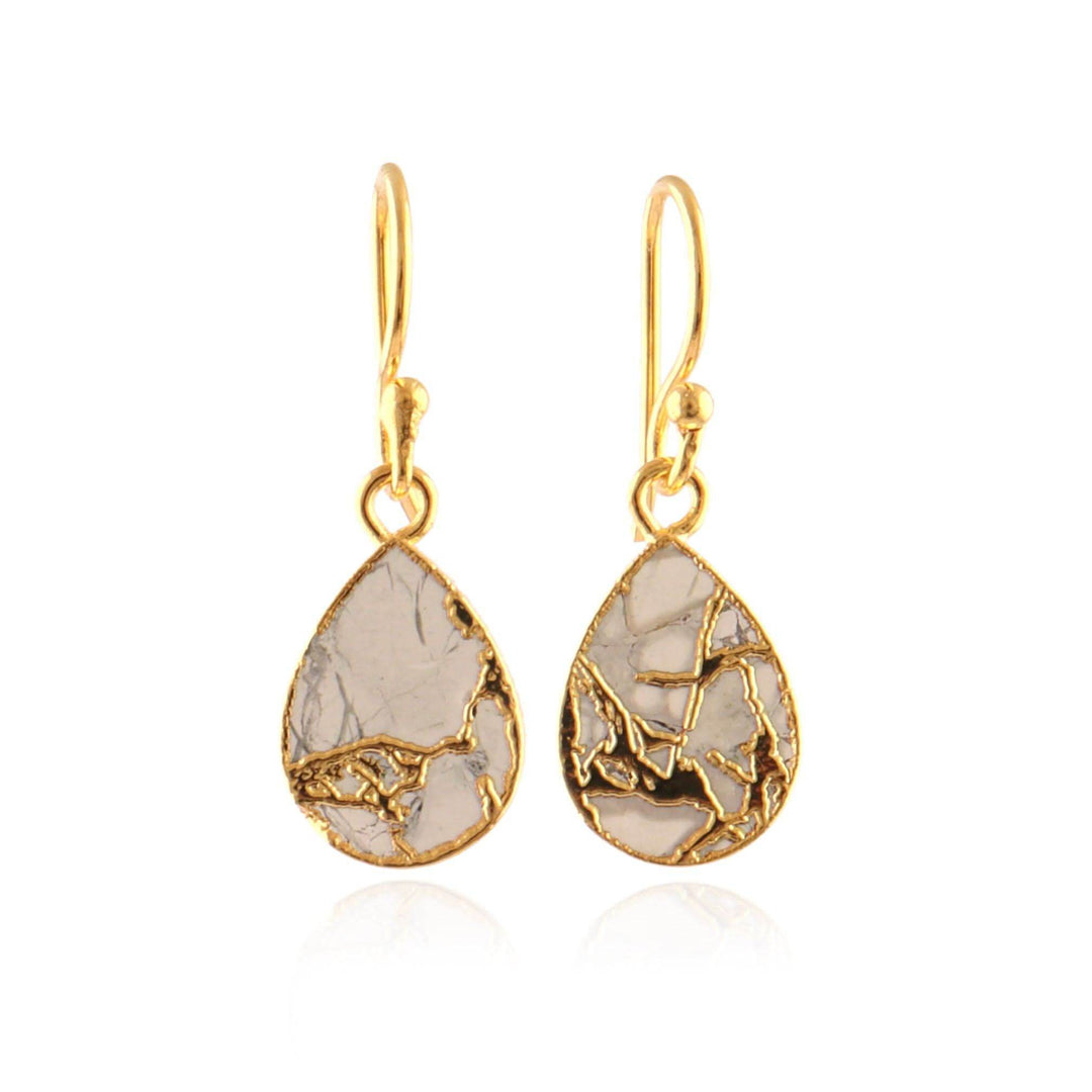 Gold teardrop earrings with a textured design on a white background
