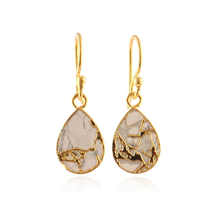 Gold teardrop earrings with a textured design on a white background