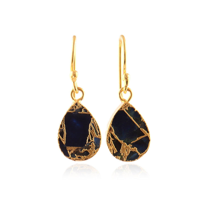Gold earrings with sapphire stones on a white background