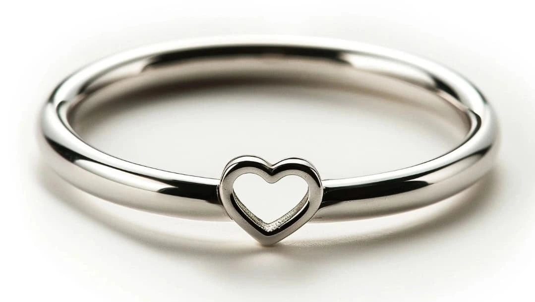 Silver ring with a heart-shaped cutout on a white background