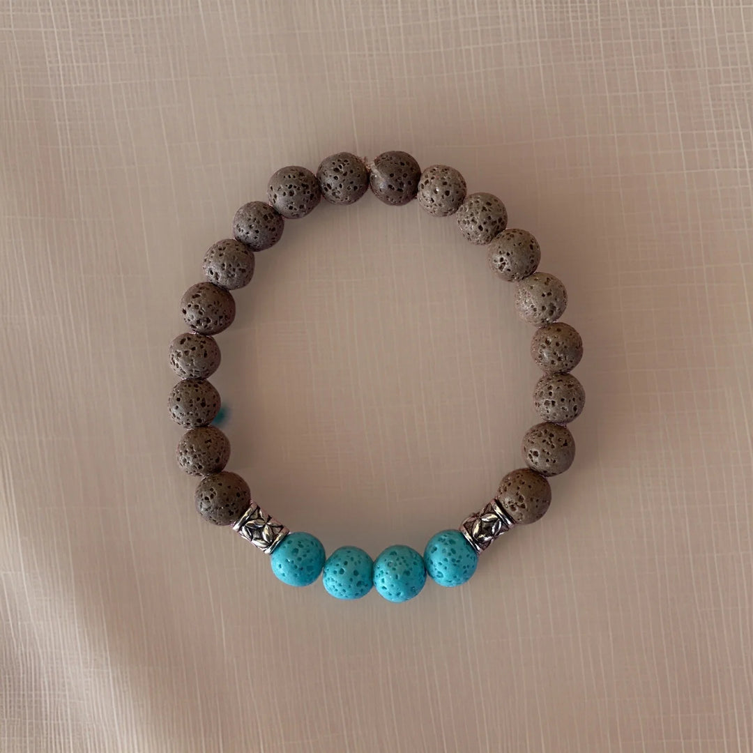 Bracelet with dark beads and turquoise stones on a beige background