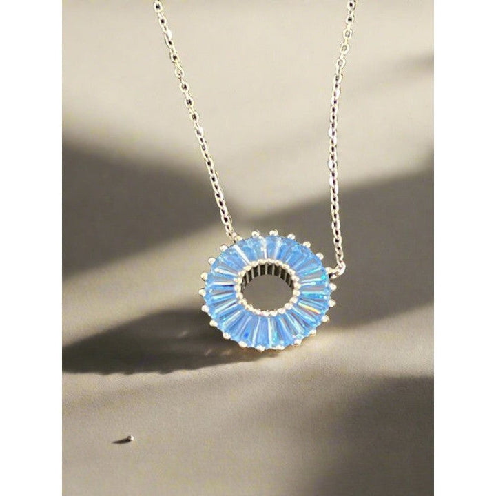 Celestial Elegance: Sterling Silver Necklace with Blue Orbit Design