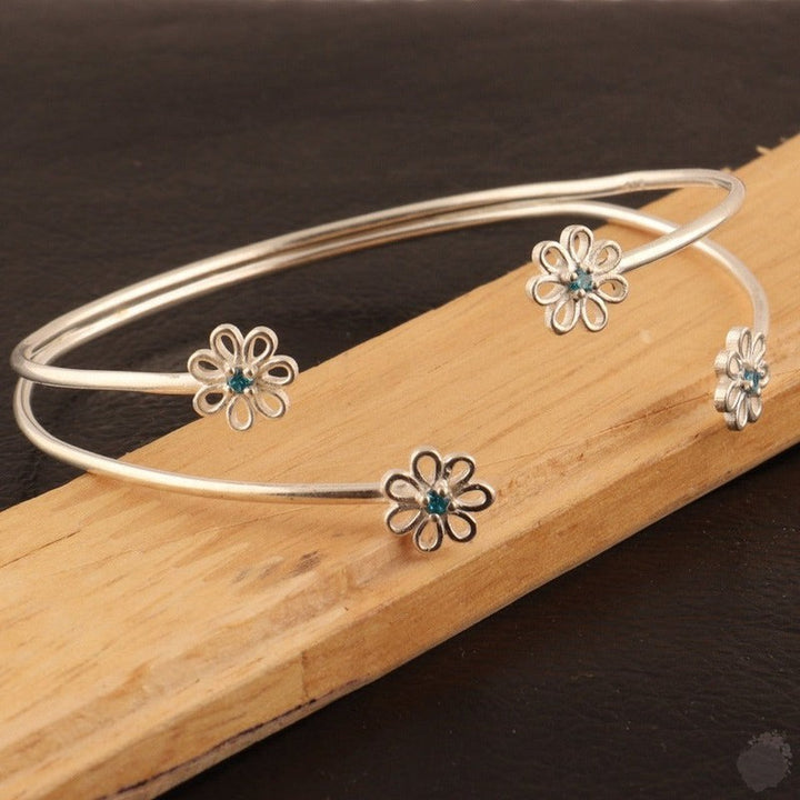 Emerald or a Blue Topaz Four Daisies Bangle