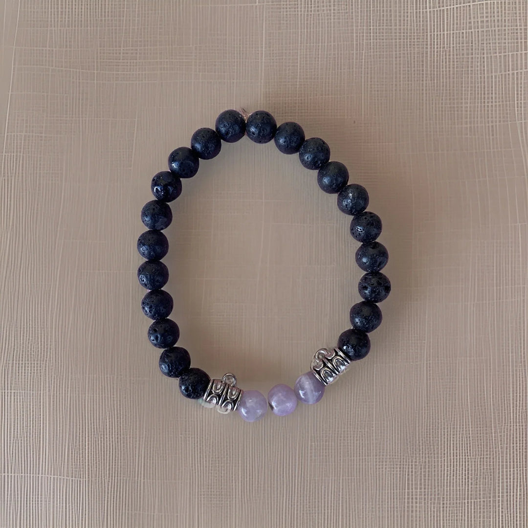 Beaded bracelet with dark blue and purple beads on a beige background