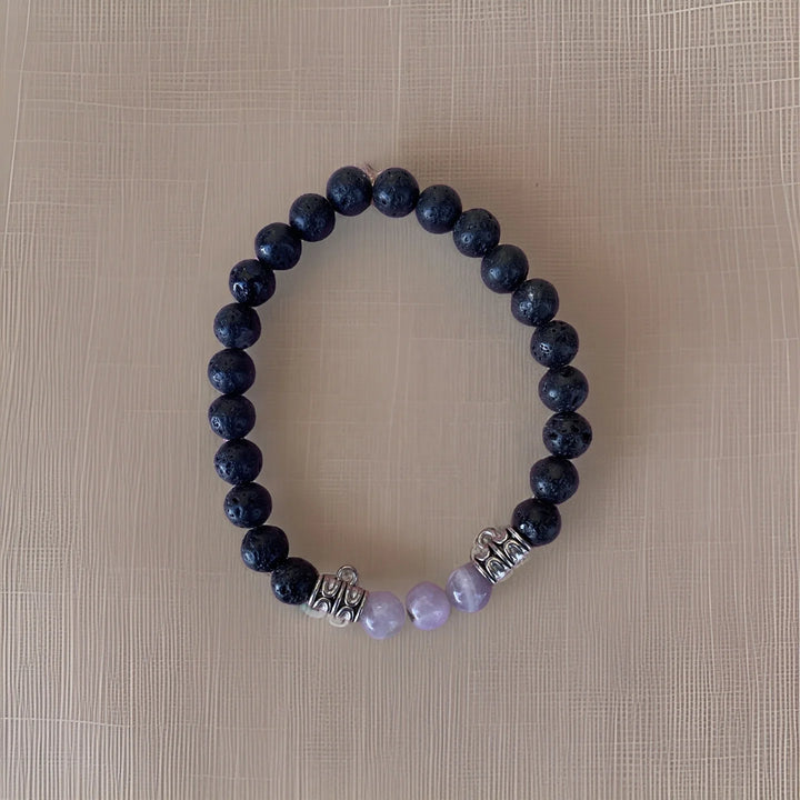 Beaded bracelet with dark blue and purple beads on a beige background