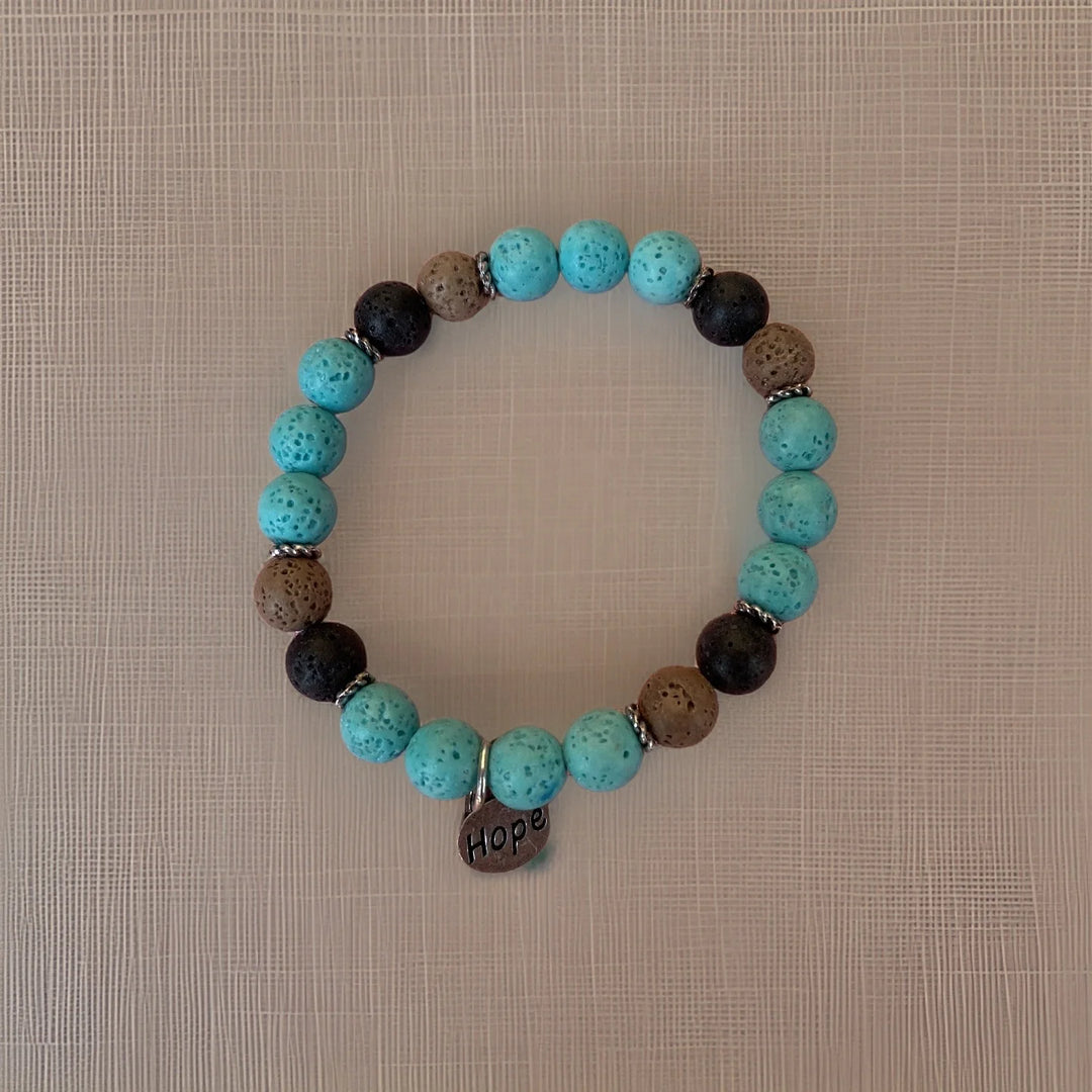 Bracelet with turquoise and brown beads on a textured beige background