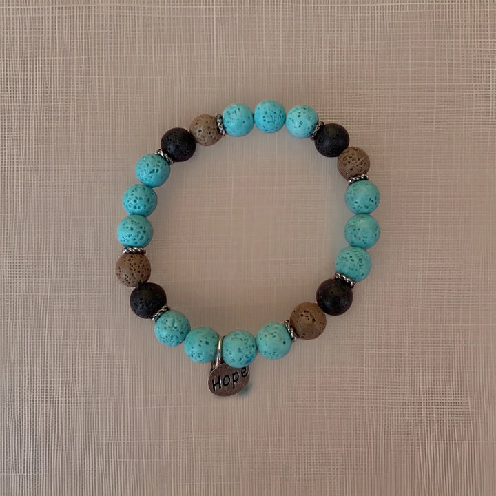 Bracelet with turquoise and brown beads on a textured beige background